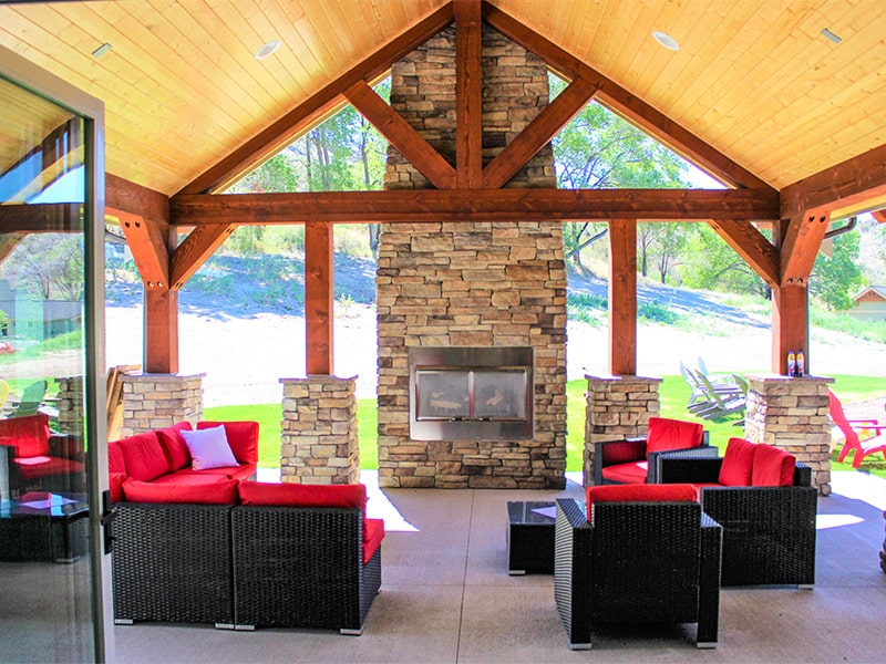 Fireplace lounge area with red chairs and couches at Tipsy Canyon Winery