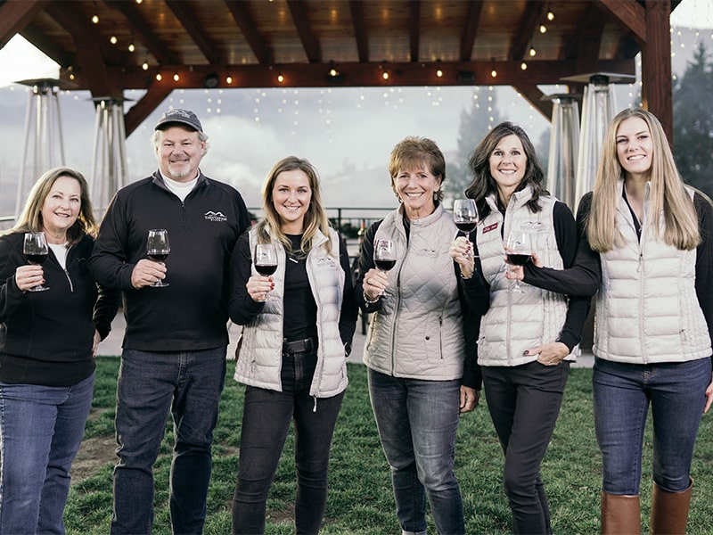 Six members of the Tipsy Canyon Winery family standing with one another while holding wine glasses