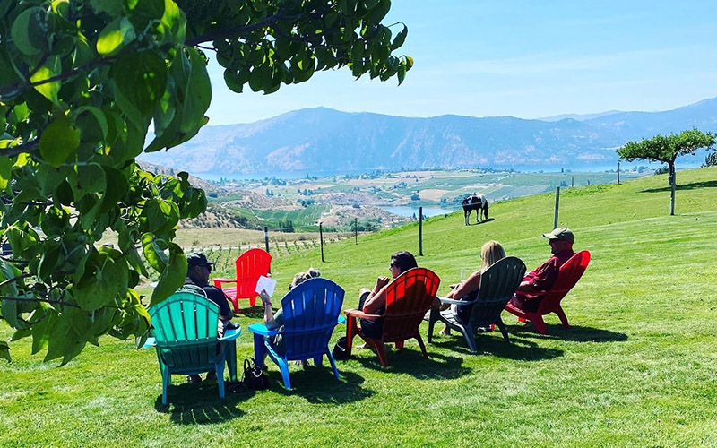 group sitting in chairs in the lawn countryside