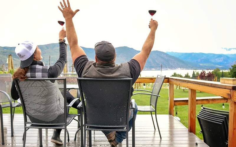 couple celebrating on patio with wine