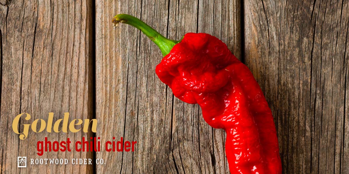 Red ghost pepper sitting on a wooden table