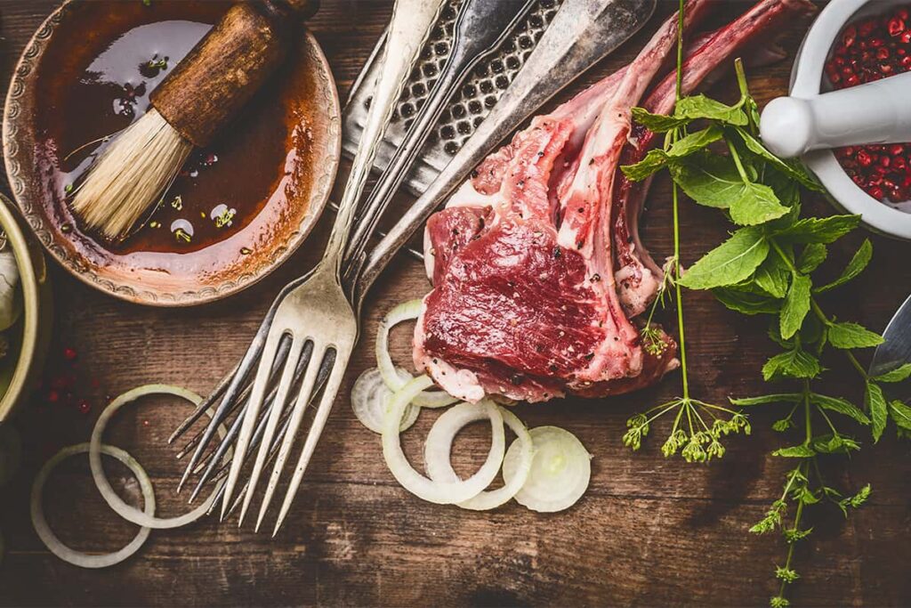 Ingredients to prepare lamb chops and mint for a wine pairing meal